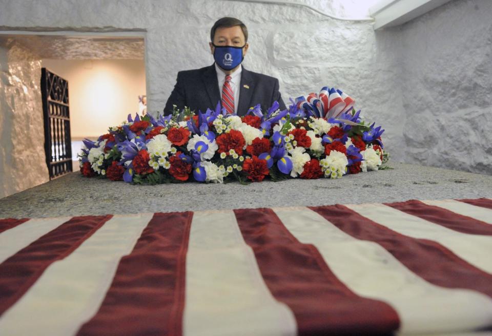 Quincy Mayor Thomas Koch pauses at the crypt of President John Adams at a ceremony honoring Adams' 285th birthday at United First Parish Church in Quincy, Friday, Oct. 30, 2020.