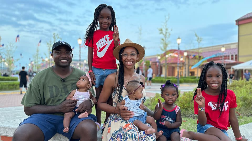 US Army Sgt. Terry Cook and his wife, Tyrese, pose with their five children at Camp Humphreys, July 4, 2024. - Yoonjung Seo/CNN