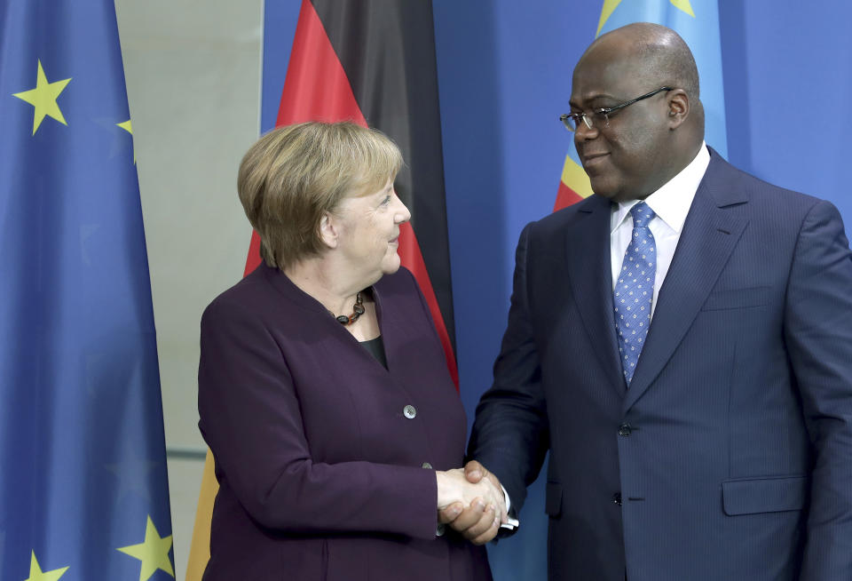 German Chancellor Angela Merkel, left, and Republic of Congo's President Felix Tshisekedi, right, shake hands after a joint press conference as part of a meeting at the chancellery in Berlin, Germany, Friday, Nov. 15, 2019. (AP Photo/Michael Sohn)