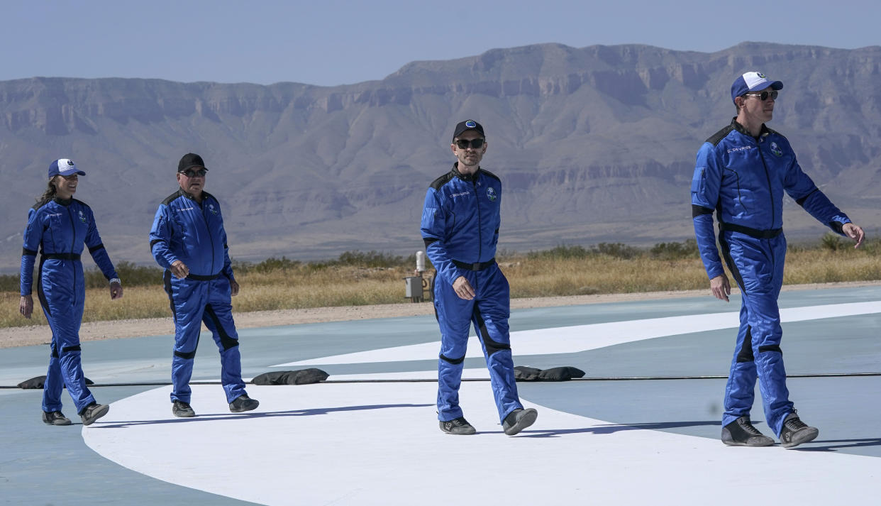 FILE - Blue Origin's New Shepard rocket latest space passengers from right, Glen de Vries, Chris Boshuizen, William Shatner and Audrey Powers walk on the booster rocker landing pad for a media availability at the spaceport near Van Horn, Texas, Wednesday, Oct. 13, 2021. Glen de Vries, 49, and Thomas P. Fischer, 54, died in crash of a single-engine Cessna 172 that went down Thursday, Nov. 11, in a wooded area of Hampton Township, N.J. (AP Photo/LM Otero, File)