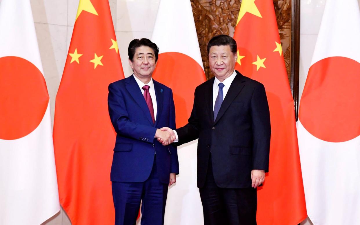 Shinzo Abe, Japan's prime minister, visits Xi Jinping, China's president, in the first state visit by a Japanese leader to China in seven years. - Kyodo News