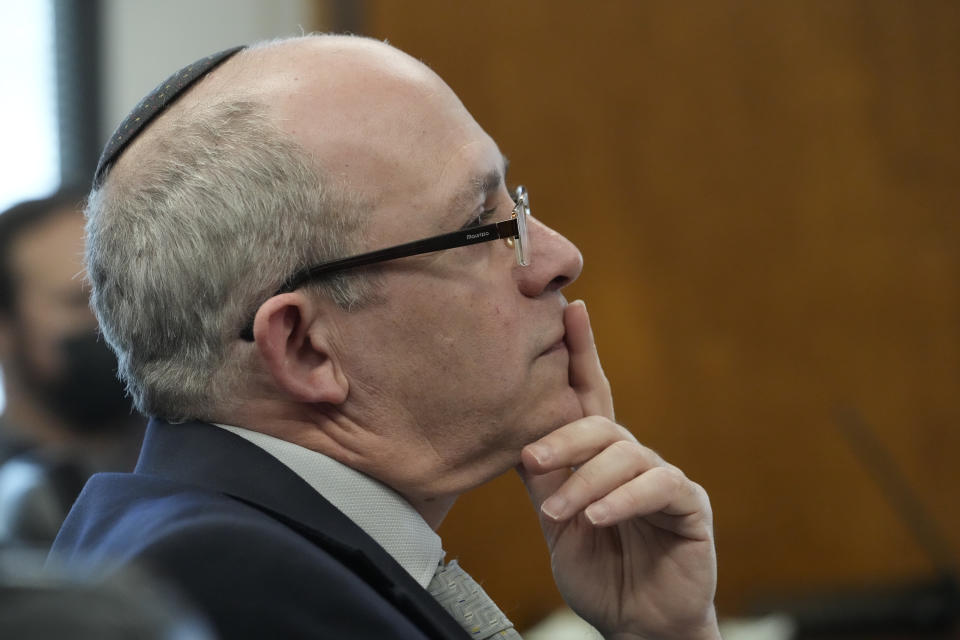 Hillel Newman, Consul General, Senior Representative of the State of Israel to the Pacific Southwest, listens to Los Angeles Mayor Karen Bass denounce anti-Semitism and hate crimes at a news conference in Los Angeles Friday, Feb. 17, 2023. A person was taken into custody Thursday in connection with the shootings of two Jewish men outside synagogues in Los Angeles this week that investigators believe were hate crimes, police said. (AP Photo/Damian Dovarganes)