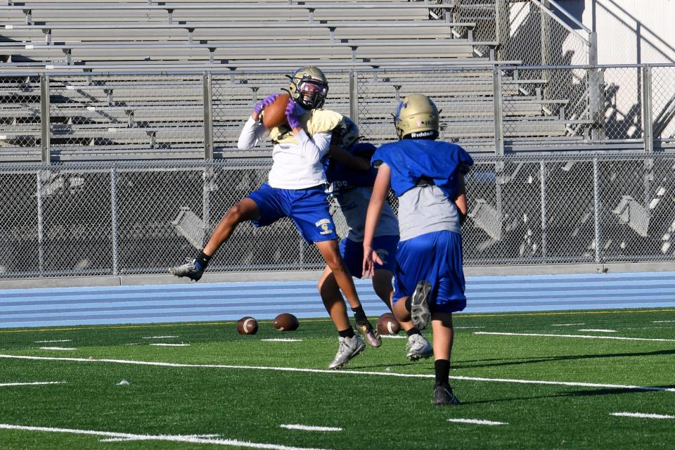 Kaleb Harrison makes a catch during a Channel Islands High football team practice on Monday, Oct. 24, 2022.