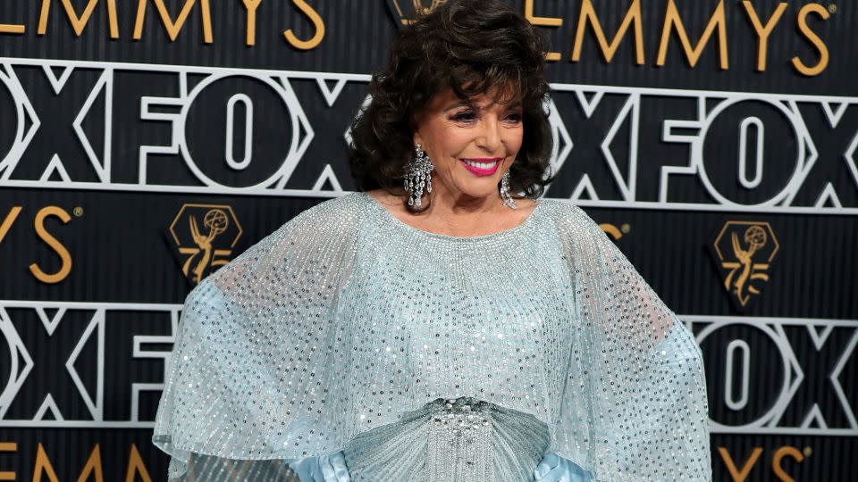 Joan Collins looked like she could have stepped off the set of a classic Hollywood movie in her Art Deco-inspired Jenny Packman sequined gown and matching opera gloves. - Danny Moloshok/Invision/AP