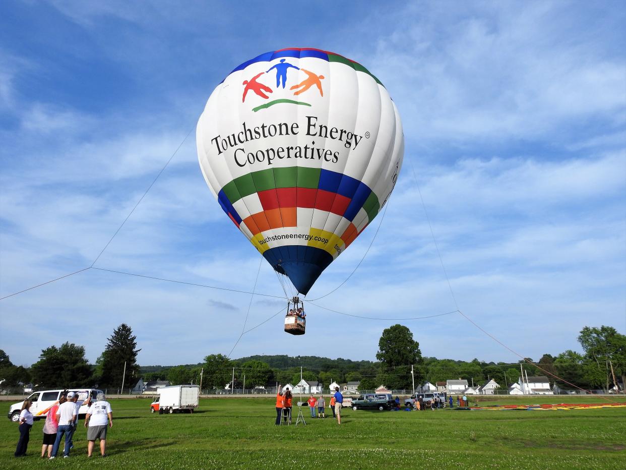 The Touchstone Energy Cooperatives hot air balloon will give tethered rides to visitors at the Coshocton Hot Air Balloon Festival at the Coshocton County Fairgrounds. The balloon will go up about 100 feet for a minute or so with passengers before coming back down.