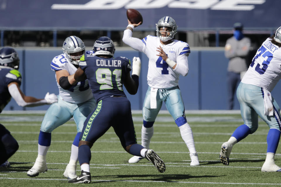 Dallas Cowboys quarterback Dak Prescott passes as Seattle Seahawks defensive end L.J. Collier blocks during the first half of an NFL football game, Sunday, Sept. 27, 2020, in Seattle. (AP Photo/John Froschauer)