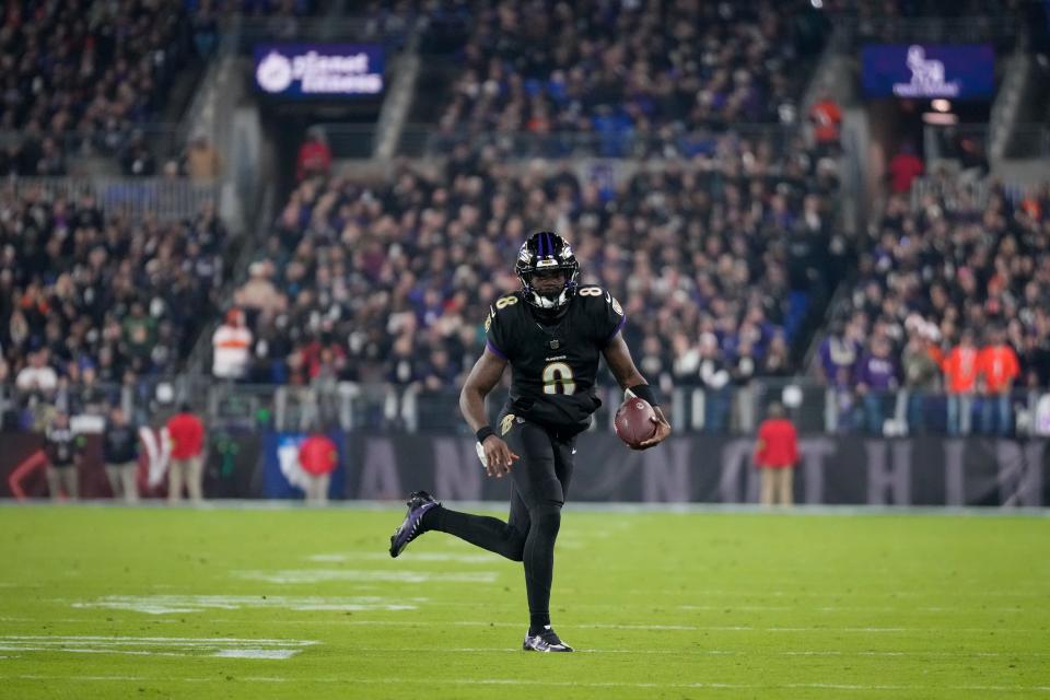 Baltimore Ravens quarterback Lamar Jackson (8) breaks away on a QB keeper in the first quarter of the NFL Week 11 game between the Baltimore Ravens and the Cincinnati Bengals at M&T Bank Stadium in Baltimore on Thursday, Nov. 16, 2023.