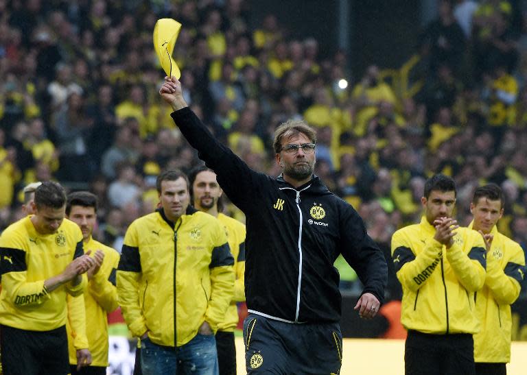 Borussia Dortmund head coach Juergen Klopp and players celebrate at the end of the Bundesliga match against SV Werder Bremen at the Signal Iduna Park on May 23, 2015