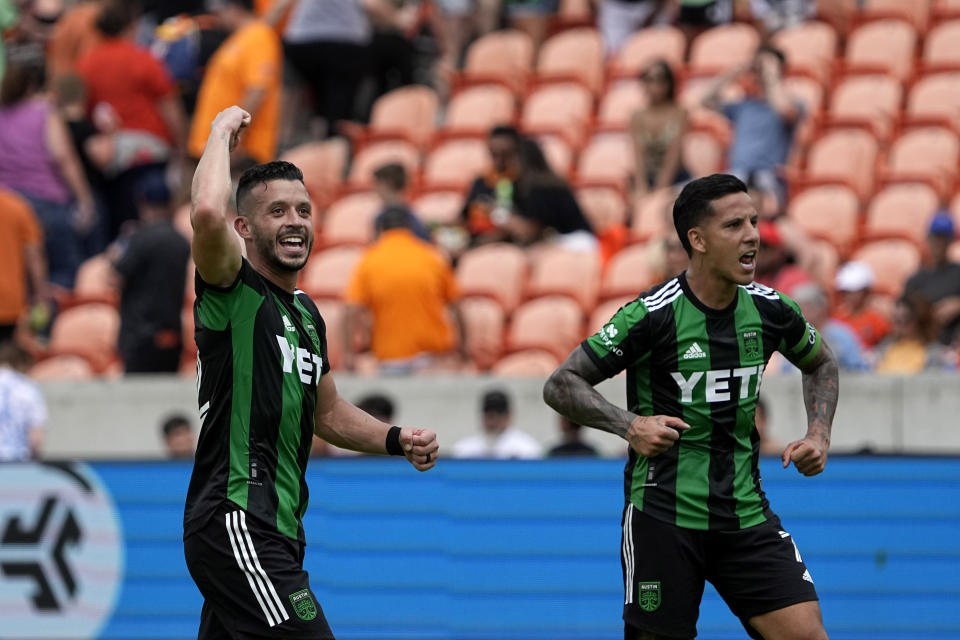 Austin FC's Felipe Martins, left, and Sebastián Driussi (7) celebrate after a MLS soccer match against the Houston Dynamo Saturday, April 30, 2022, in Houston. Austin FC won 2-1. (AP Photo/David J. Phillip)