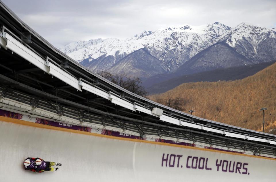 The doubles team of Tobias Wendl and Tobias Arlt from Germany speed down the track during a training session for men's doubles luge at the 2014 Winter Olympics, Monday, Feb. 10, 2014, in Krasnaya Polyana, Russia. (AP Photo/Jae C. Hong)