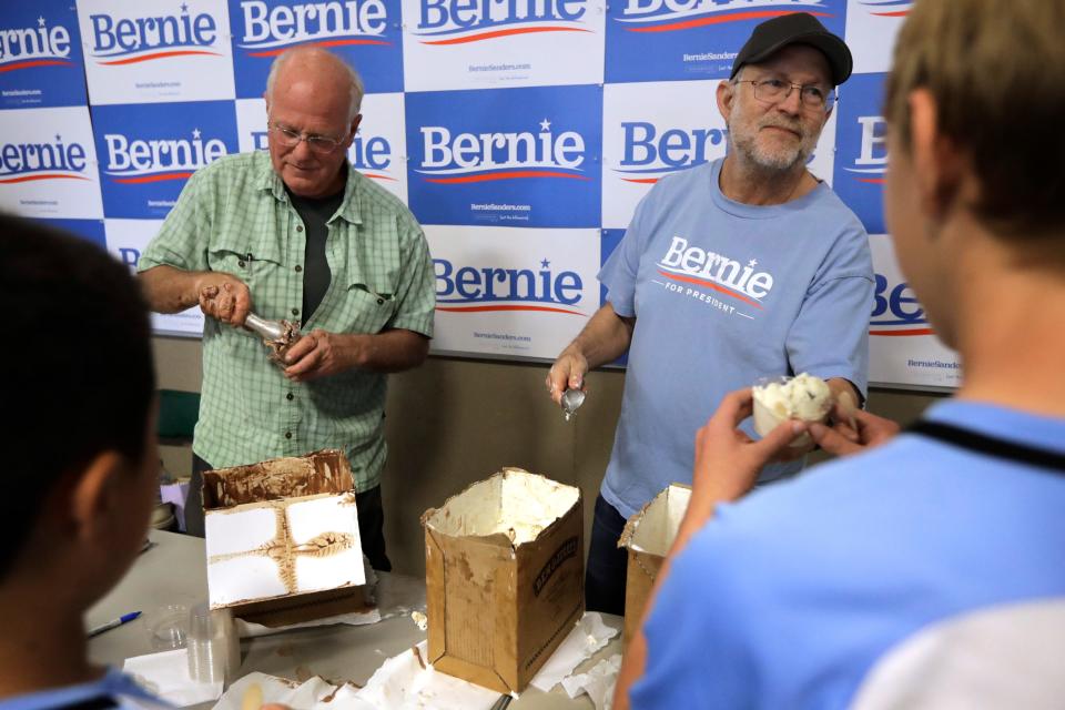Ben & Jerry's co-founder Ben Cohen, center left, and fellow co-founder Jerry Greenfield, center right, scoop ice cream before a campaign event for Sen. Bernie Sanders, I-Vt., not shown, Sunday, Sept. 1, 2019, in Raymond, N.H.