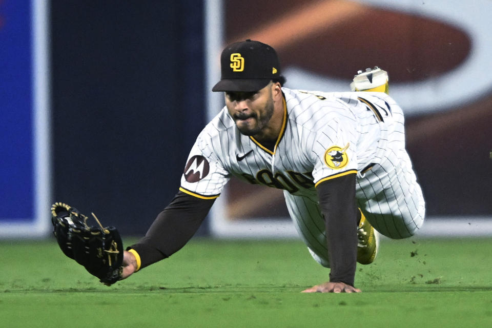 San Diego Padres center fielder Trent Grisham makes a diving catch on a ball hit by Cleveland Guardians' Josh Bell during the fifth inning of a baseball game Wednesday, June 14, 2023, in San Diego. (AP Photo/Denis Poroy)