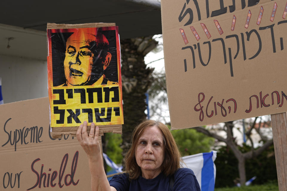 Israelis protest Prime Minister Benjamin Netanyahu's government plans to overhaul the judicial system ahead of the weekly cabinet meeting in Sderot, Israel, near the border with the Gaza Strip, Thursday, April 20, 2023. Hebrew reads: "destruction of Israel." (AP Photo/Tsafrir Abayov)