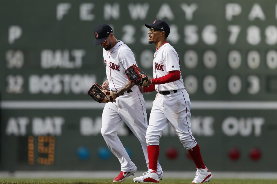 Boston Red Sox's Mookie Betts, right, and Blake Swihart head in after defeating the Baltimore Orioles during a baseball game in Boston, Sunday, April 14, 2019. (AP Photo/Michael Dwyer)