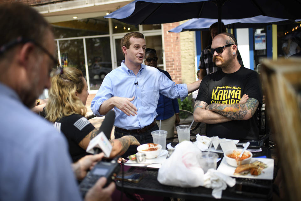 Dan McCready, a Democratic candidate for North Carolina's 9th District, talks to Johnny Ivey while campaigning on Hay Street on Monday, Sept. 9, 2019, in Fayetteville, N.C. (Andrew Craft/The Fayetteville Observer via AP)