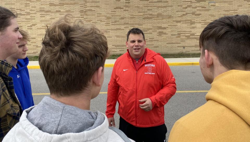 New Bedford boys track and field coach Stefan Wilkinson talks to some of his athletes before a recent practice. The former football and track coach at Morenci stepped up following the sudden death of last year's coach Scott Earl.