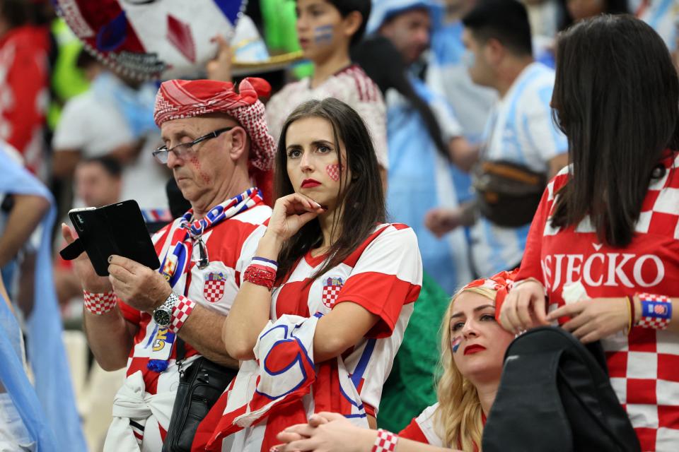 Croatia supporters look dejected after their team lost the Qatar 2022 World Cup football semi-final match between Argentina and Croatia at Lusail Stadium in Lusail, north of Doha on December 13, 2022. (Photo by JACK GUEZ / AFP) (Photo by JACK GUEZ/AFP via Getty Images)