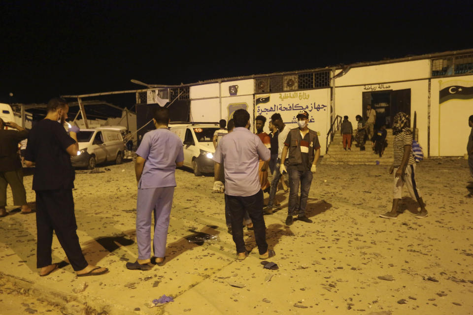 Workers gather at a detention center after an airstrike in Tajoura, east of Tripoli Wednesday, July 3, 2019. An airstrike hit the detention center for migrants early Wednesday in the Libyan capital. (AP Photo/Hazem Ahmed)