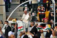 Pope Francis waves as he arrives for an open air Mass at a stadium in Irbil, Iraq, Sunday, March 7, 2021. Thousands of people filled the sports stadium in the northern city of Irbil for Pope Francis’ final event in his visit to Iraq: an open-air Mass featuring a statue of the Virgin Mary that was restored after Islamic militants chopped of the head and hands. (AP Photo/Hadi Mizban)