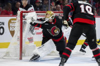 Ottawa Senators goaltender Joonas Korpisalo, center, fails to make a save on a shot by New Jersey Devils centre Nico Hischier (not shown) during second-period NHL hockey game action in Ottawa, Ontario, Saturday, April 6, 2024. (Spencer Colby/The Canadian Press via AP)