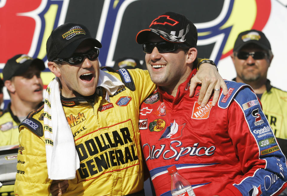 FILE - In this April 28, 2007, file photo, Bobby Labonte, left, and Tony Stewart, right, celebrate Labonte's win in the NASCAR Busch Series' Aaron's 312 auto race at Talladega Superspeedway in Talladega, Ala. Joe Gibbs, already an NFL Hall of Famer, will be inducted into the NASCAR Hall of Fame alongside Tony Stewart and Bobby Labonte, two drivers who helped him build one of NASCAR’s top teams while giving “Coach Joe” three of the organization’s five titles. (AP Photo/Rob Carr, File)