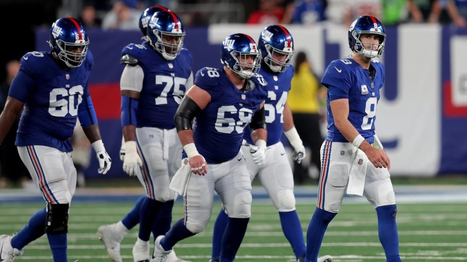 Oct 2, 2023; East Rutherford, New Jersey, USA; New York Giants quarterback Daniel Jones (8) walks off the field with guards Marcus McKethan (60) and Joshua Ezeudu (75) and Ben Bredeson (68) and Mark Glowinski (64) after being sacked during the fourth quarter against the Seattle Seahawks at MetLife Stadium.