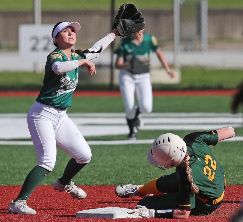 St. Vincent-St. Mary shortstop Sydney Shaker looks for the throw as Medina runner Ryan Allar takes second base during their game at Firestone Stadium.