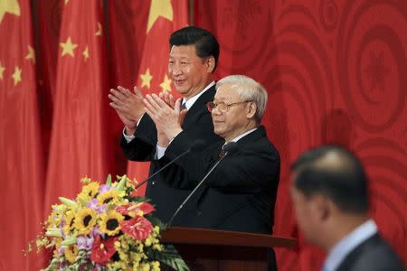 Chinese President Xi Jinping (L) and Vietnamese Communist Party General Secretary Nguyen Phu Trong applaud at a meeting with Vietnamese and Chinese communist youths in Hanoi, Vietnam, November 6, 2015. REUTERS/Na Son Nguyen/Pool