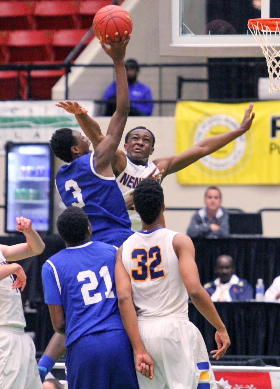 Cardinal Newman's Abdul Dial tries to block Godby's Quan Jackson from scoring during the FHSAA Finals last month in Lakeland.