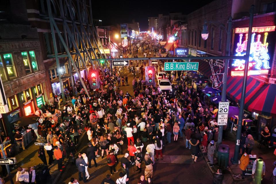 Revelers take to Beale Street in Downtown Memphis, Tenn. to celebrate New Year's Eve on Friday, Dec. 31, 2021. 