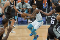 Charlotte Hornets guard Malik Monk (1) works the ball past Sacramento Kings defenders during the first quarter of an NBA basketball game in Sacramento, Calif., Sunday, Feb. 28, 2021. (AP Photo/Randall Benton)