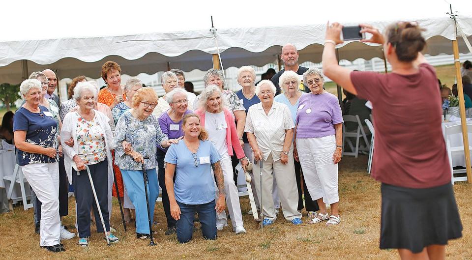 Karen Johnston, right, director of Weymouth Elder Services, takes a photo of Weymouth volunteers. Norfolk County RSVP volunteers were treated to a luncheon and awards for their volunteer work by the Norfolk Count Commissioners at the Endicott Estate in Dedham on Thursday, Aug. 11, 2022.