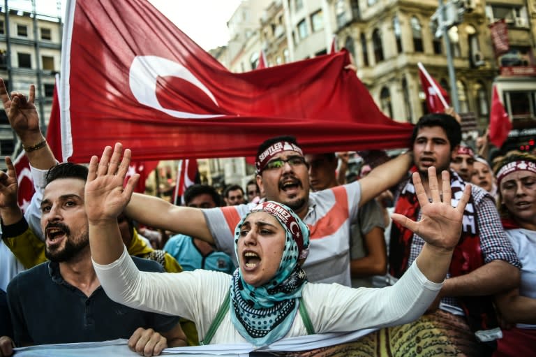 People wave Turkish flags and shout nationalist slogans during a demonstration against the Kurdistan Workers' Party (PKK) on August 16, 2015 on Istiklal avenue in Istanbul