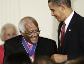 FILE - US President Barack Obama presents a 2009 Presidential Medal of Freedom to Desmond Tutu, widely regarded as "South Africa's moral conscience," who was a leading anti-apartheid activist in South Africa., Wednesday, Aug. 12, 2009, in the East Room of the White House in Washington. South Africa’s Nobel Peace Prize-winning activist for racial justice and LGBT rights and the retired Anglican Archbishop of Cape Town, has died at the age of 90, it was announced on Sunday, Dec. 26, 2021. An uncompromising foe of apartheid, South Africa’s brutal regime of oppression again the Black majority, Tutu worked tirelessly, but non-violently, for its downfall. (AP Photo/J. Scott Applewhite, File)