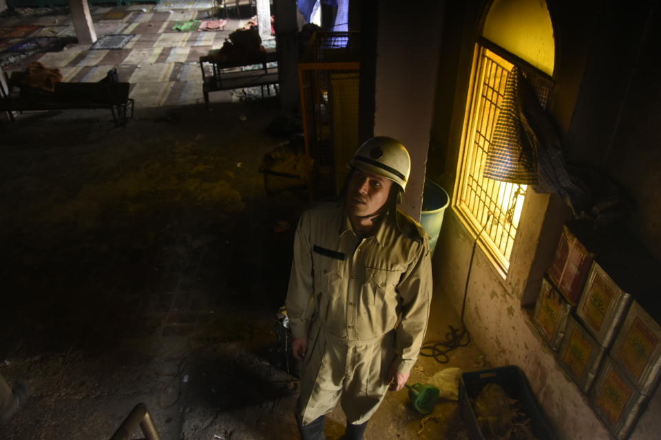 DELHI, INDIA - FEBRUARY 26 : A firefighter inspect the damaged and burnt Farooquiya Madrasah following the Citizenship Amendment Act (CAA) clashes in Mustafabad, Delhi, India on February 26, 2020. (Photo by Javed Sultan/Anadolu Agency via Getty Images)