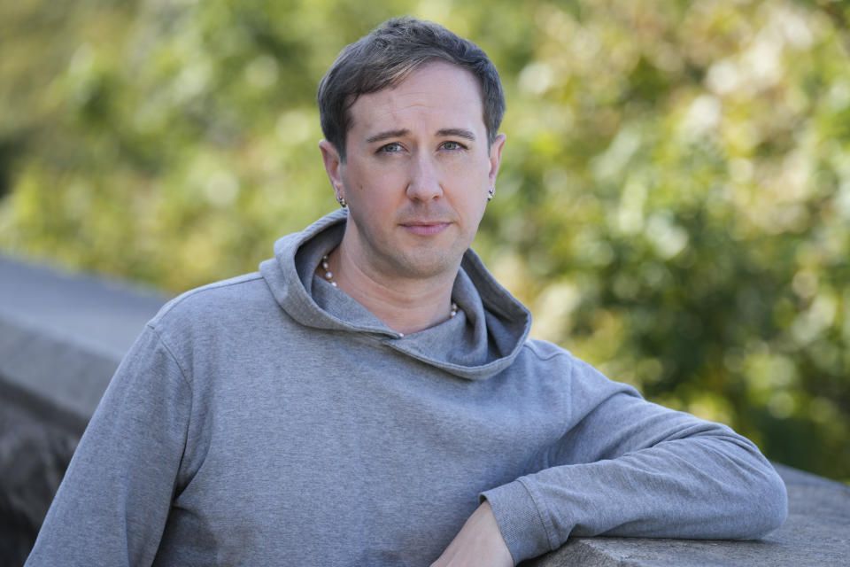 Samuel Schultz poses for a picture near his his home, Monday, Oct. 9, 2023 in New York. It took eight years and the burgeoning #MeToo movement to spur them to go public and make a police report, and an additional five years for their attackers to plead guilty. Now, as much as Schultz hopes there’s a reckoning coming in gay and queer communities, too, it feels like they are the one shouldering the blame, not the attackers: for coming forward, for harming the men’s reputations. (AP Photo/Seth Wenig)