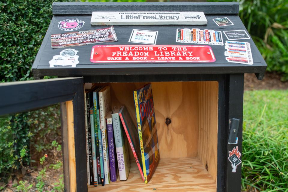 Heather Encinosa stocks her “Little Free Library,” located in Betton Hills, with banned books, giving the public access to reading books that have been banned in Florida schools.
(Credit: Alicia Devine/Tallahassee Democrat)