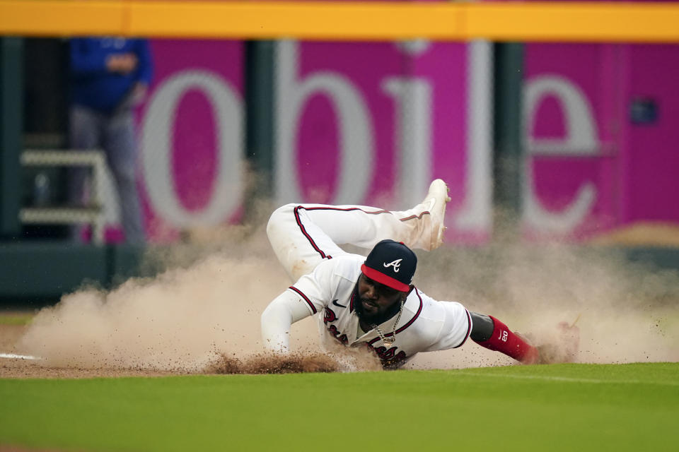 Atlanta Braves left fielder Marcell Ozuna (20) makes a diving attempt for a double by Chicago Cubs' Rafael Ortega during the third inning of a baseball game Wednesday, April 27, 2022, in Atlanta. (AP Photo/John Bazemore)
