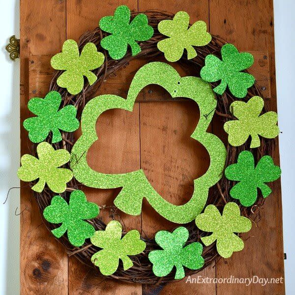 grapevine wreath with glittery shamrocks overlaid on it