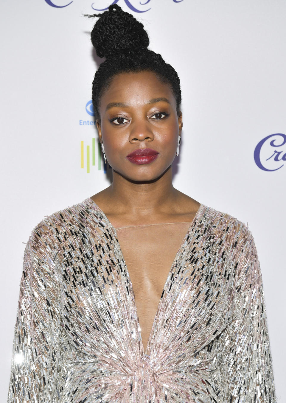 A woman in a silver sparkly dress, looking ahead