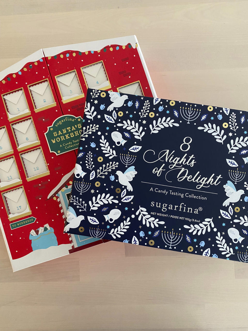 This image shows two advent calendar offerings by Sugarfina, one in the guise of Santa’s Workshop, left, and 8 Nights of Delight- Hanukkah Candy Tasting Collection reveals a new kosher-certified candy. (Katie Workman via AP)