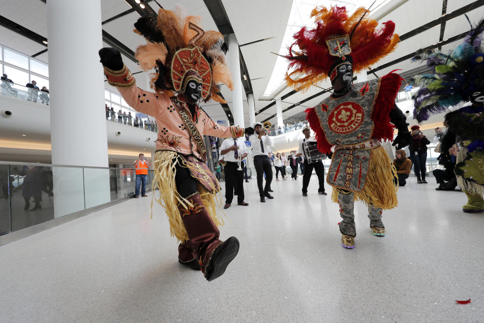 CORRECTS CITY TO KENNER, NOT BATON ROUGE- Members of the Zulu Social Aid & Pleasure Club Tramps lead a second line parade down escalators during festivities for the opening of the newly built main terminal of the Louis Armstrong New Orleans International Airport in Kenner, La., Tuesday, Nov. 5, 2019. (AP Photo/Gerald Herbert)