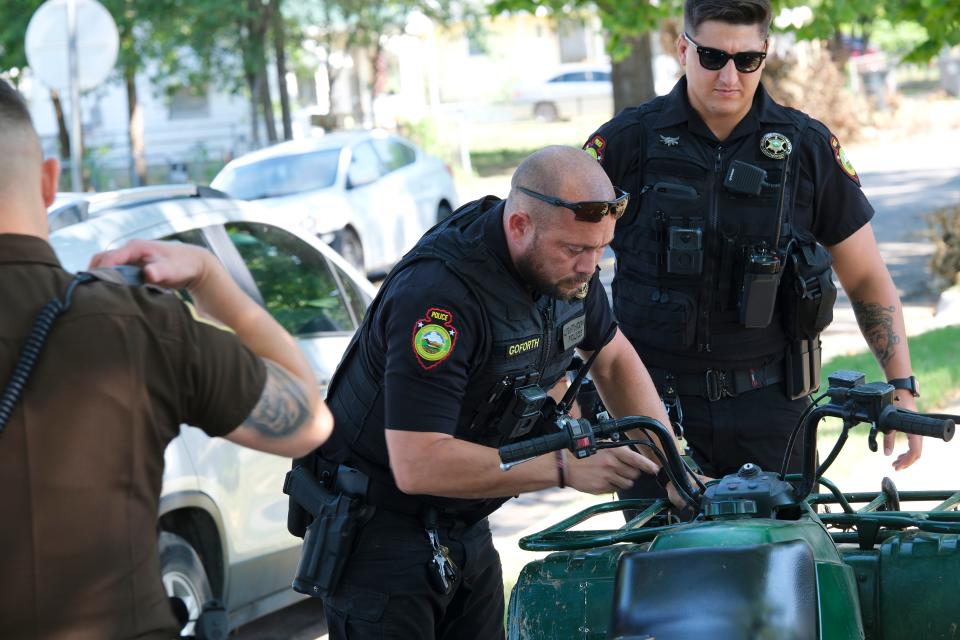 Muscogee Nation Lighthorse Police Officers Chris Goforth, middle, and Daryl Wilson, right, assist an Oklahoma Highway Patrol trooper after he arrested a man in Tulsa on July 3. Lighthorse officers police the large part of east-central Oklahoma that makes up the Muscogee Nation reservation.