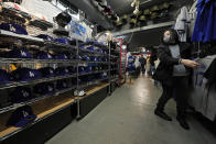 A customer shops for goods related to Shohei Ohtani of the Los Angeles Dodgers for her father at SELECTION, a sporting goods store in Shinjuku district of Tokyo, Thursday, Feb. 29, 2024. (AP Photo/Hiro Komae)