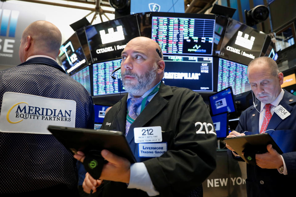 Traders work on the floor at the New York Stock Exchange (NYSE) in New York, U.S., October 21, 2019. REUTERS/Brendan McDermid