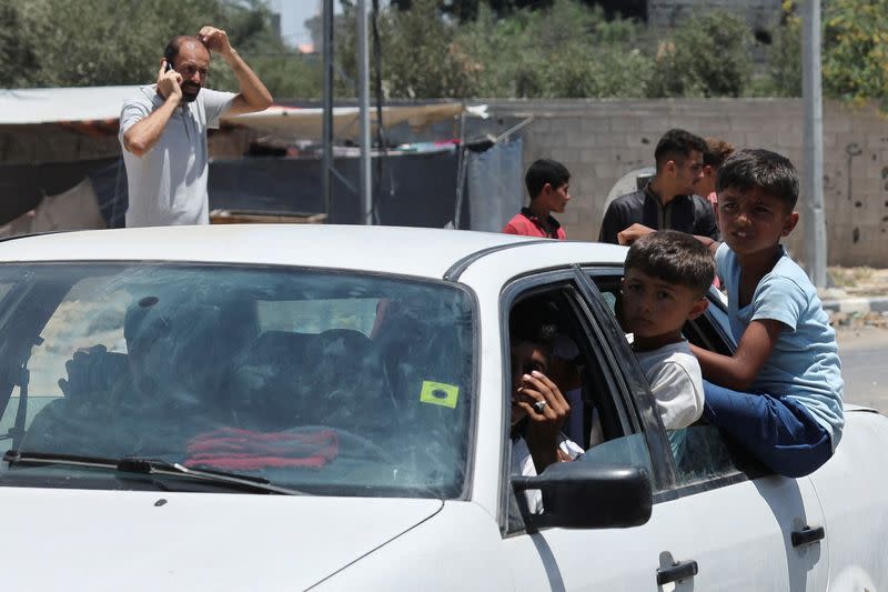 Displaced Palestinian children, who fled north Gaza after they were ordered by Israeli army to move southward, amid Israel-Hamas conflict, travel in a car as they arrive in Nuseirat in the central Gaza Strip