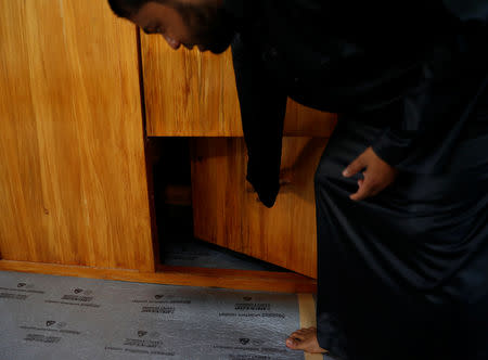 Mohammed Israfil Hossain, a muazzin from Bangladesh, shows an opening in the pulpit where a three-year-old boy hid during the shootings at Al Noor mosque where more than 40 people were killed by a suspected white supremacist during Friday prayers on March 15 in Christchurch, New Zealand April 1, 2019. REUTERS/Edgar Su