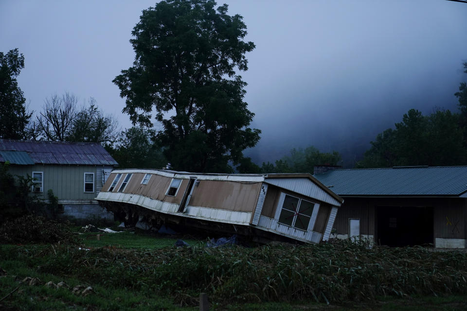 A trailer home was swept away by massive flooding on Friday, Aug. 5, 2022, near Lost Creek, Ky. As residents continued cleaning up from the late July floods that several people, rain started falling on already saturated ground in eastern Kentucky late Friday morning. (AP Photo/Brynn Anderson)