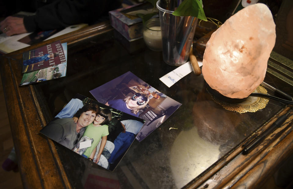 Childhood photos of Daniel Aston rest on a side table in his family's home in Colorado Springs, Colo., on Sunday, Nov. 20, 2022. The 28-year-old was one of five people killed when a gunman opened fire in a gay nightclub in Colorado Springs on Saturday night. (AP Photo/Thomas Peipert)