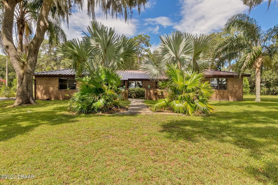 This exquisitely maintained, custom brick pool home rests below the swaying oaks on nearly four acres of serenity in DeLeon Springs.